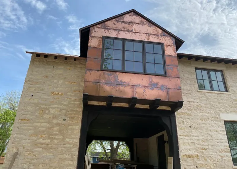 Copper metal panel facade on a stone building for Skylight Installation in Vero Lake Estates