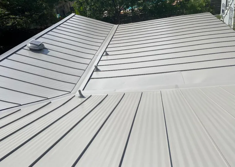 Solar attic fan installed on a metal roof for Roof Ventilation in Vero Lake Estates