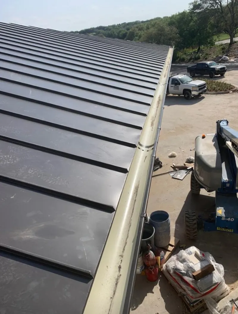 Standing seam panel and gutter detail on a metal roofing jobsite in Vero Lake Estates